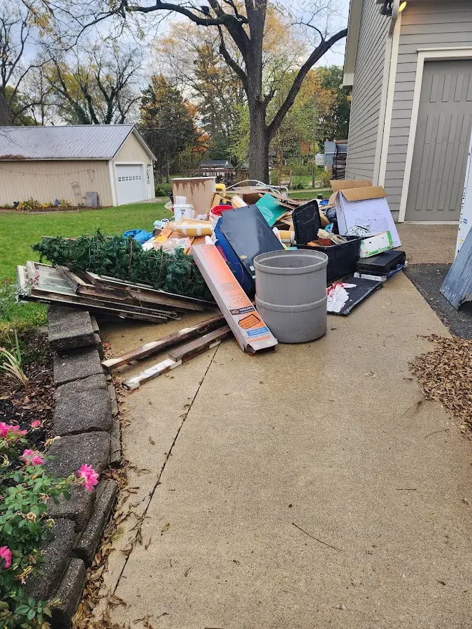 Dumpster being loaded with debris for 3 Yard Dumpster Rental in Roswell